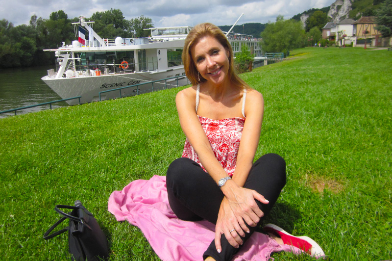 Catriona pictured with Scenic Gem which sails the Seine River in Northern France. Image: Scenic