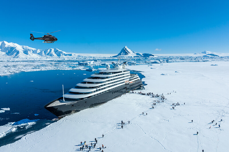 Scenic Eclipse and guests steping on the sea ice at Hanusse