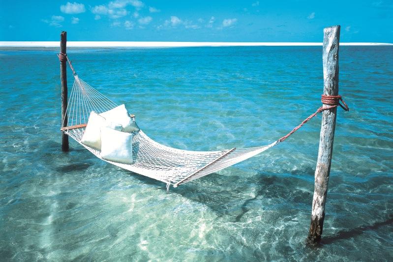 Hammock hangs over turquoise water