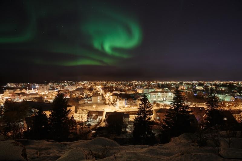 Northern lights over city in Iceland